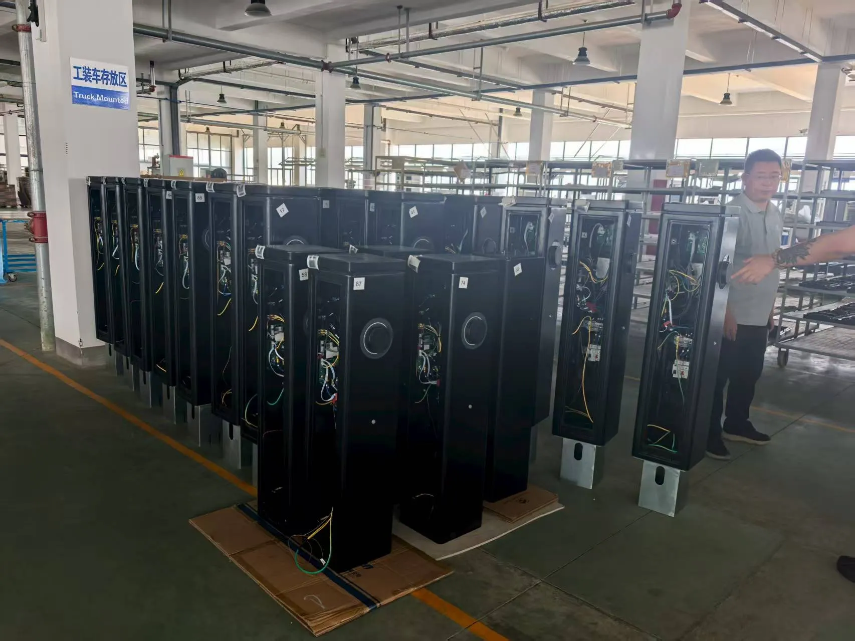 A batch of dual-port AC charging pedestals in final assembly at the VULTAE factory