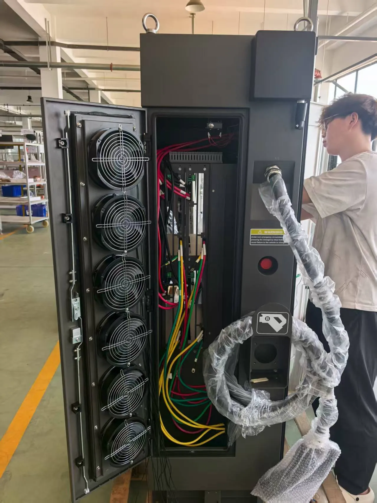 Power modules and wiring inside a DC fast charger during assembly